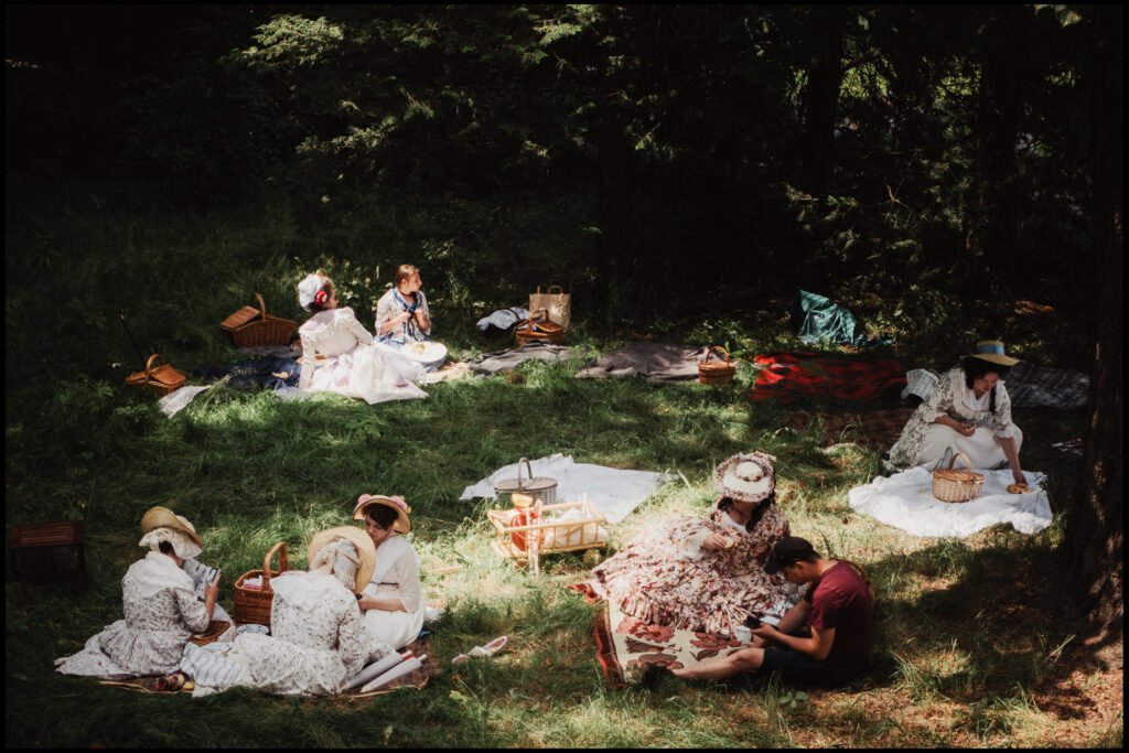 A surreal picnic scene with a time traveler, the featured image for the first post on my new photography blog. This is street and documentary photography.